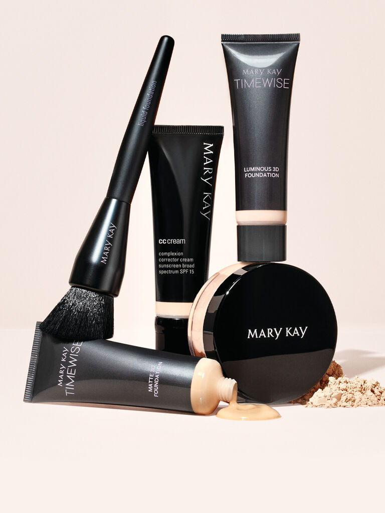 Group shot of Mary Kay Timewise Foundations, CC Cream, Loose Powder, and foundation brush