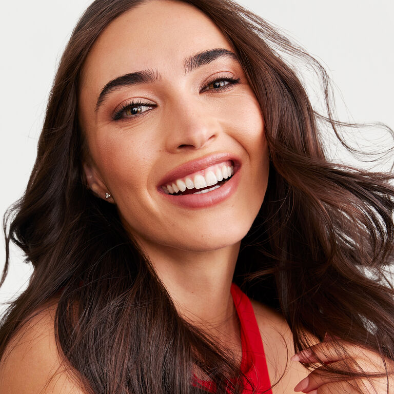 A model wearing the Saharan Dusk look appears smiling