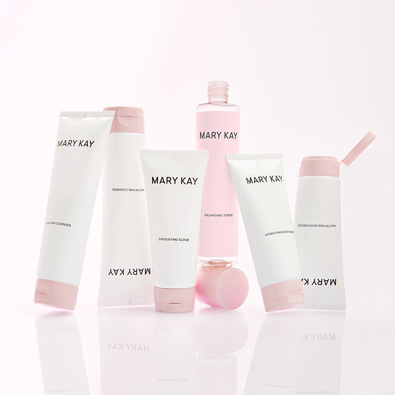 The moisturizing and mattifying Mary Kay skincare sets are placed side by side on a mirrored surface and a white background.