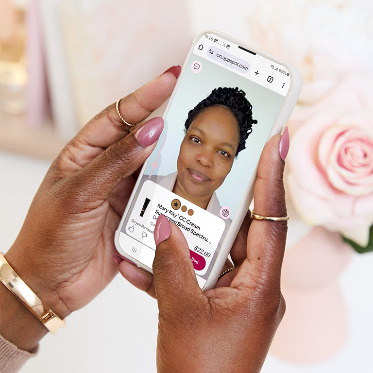 A woman is trying out the foundation matching tool on her phone.